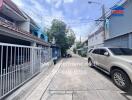 Residential street with houses and parked cars