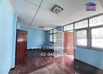 Bedroom with wooden flooring and blue walls