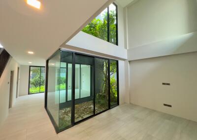 Modern atrium with glass walls and indoor garden