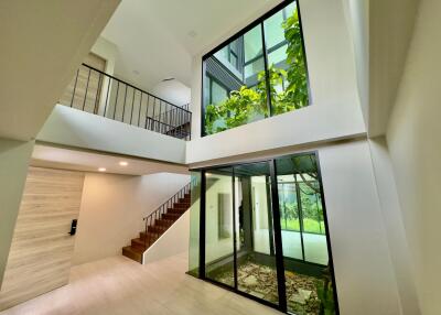 Modern multi-level home with large windows and indoor garden