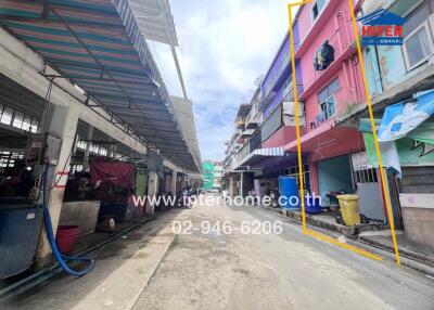 Street view of a row of buildings showcasing a residential area