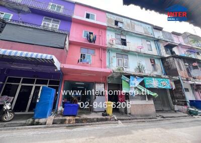 Exterior view of a multi-story residential building with colorful facades