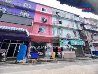 Exterior view of a multi-story residential building with colorful facades