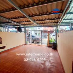 Covered area with tiled flooring and gate access