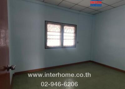 Empty bedroom with tiled ceiling and barred windows