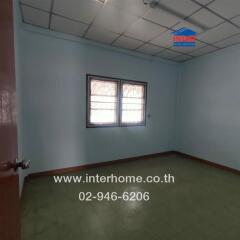 Empty bedroom with tiled ceiling and barred windows