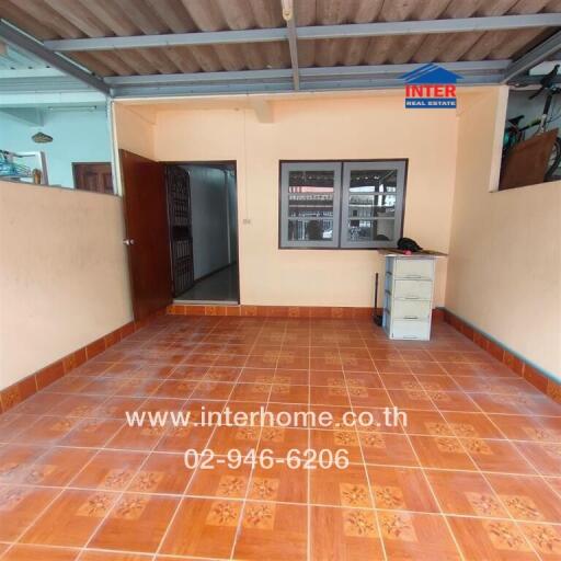 Front view of a property with tiled flooring and an open workspace.