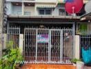 Exterior view of a townhouse with gated entrance