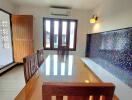 Dining room with wooden table and mosaic tile accent wall