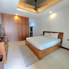 Master bedroom with wooden furniture and large wardrobe