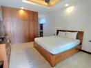 Master bedroom with wooden furniture and large wardrobe