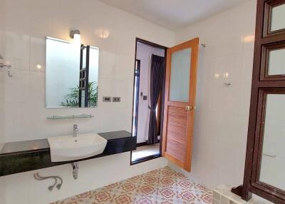 Modern bathroom with sink, mirror, and patterned tiles