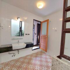 Modern bathroom with sink, mirror, and patterned tiles