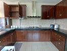 Modern kitchen with dark wood cabinets and built-in appliances