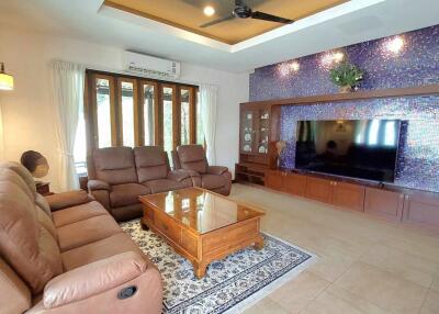 Spacious living room with comfortable seating and large TV