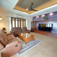 Spacious living room with comfortable seating and large TV