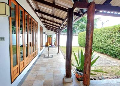 Covered walkway with wooden elements and tile flooring