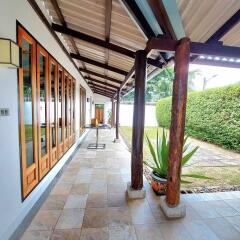 Covered walkway with wooden elements and tile flooring