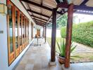 Covered walkway with wooden elements and tile flooring