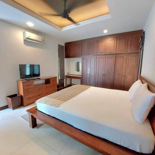 Spacious modern bedroom with wooden furniture