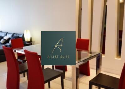 Modern living and dining area with glass table and red chairs