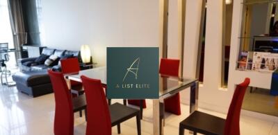 Modern living and dining area with glass table and red chairs