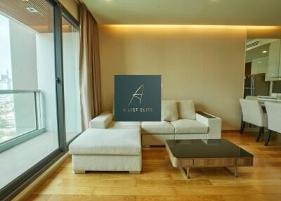 Elegant living room with city view, attached to a modern kitchen