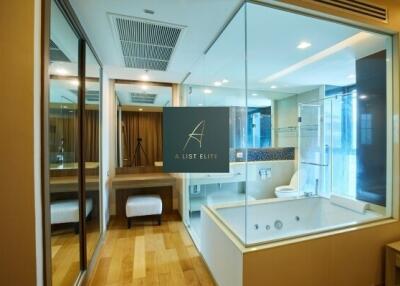 Modern bathroom with glass partitions and wooden flooring