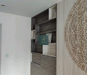 modern bedroom with built-in wooden shelves and decorative wall art