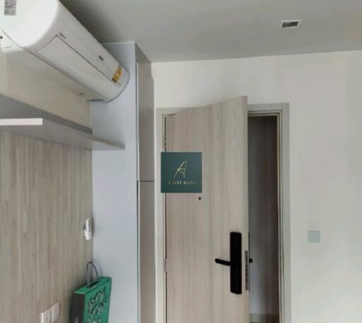 Image of apartment entryway with a door and air conditioning unit