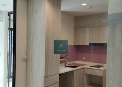 Modern kitchen with wooden cabinets and pink backsplash