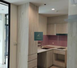 Modern kitchen with wooden cabinets and pink backsplash