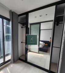 Modern bedroom with large mirror and sliding door wardrobe