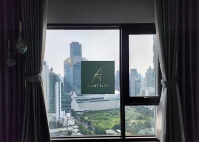 View of cityscape with tall buildings from a window with curtains