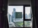 View of cityscape with tall buildings from a window with curtains