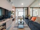 Modern living room with a TV, sofa, and glass doors leading to a bedroom