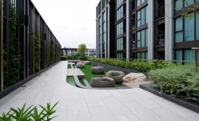 Modern outdoor communal area with seating and greenery