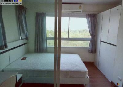 Spacious bedroom with large window and ample storage