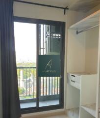 Bedroom with a balcony view and closet space