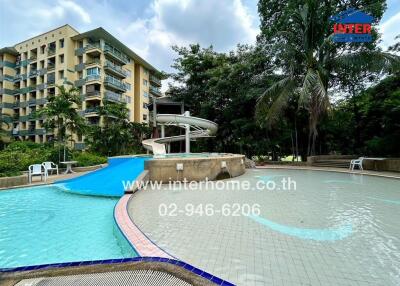 Swimming pool with water slide in a residential complex