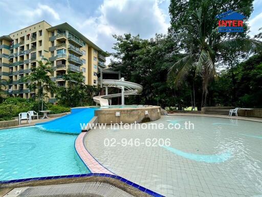 Swimming pool with water slide in a residential complex