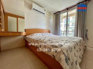 Cozy bedroom with large window and air conditioner