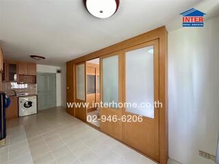 Modern kitchen with washing machine and storage cabinets