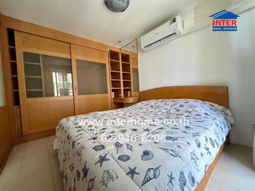 Bedroom with wooden furniture and air conditioning