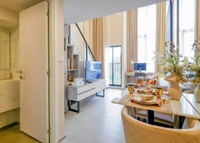 Modern living area with high ceilings and dining table