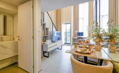 Modern living area with high ceilings and dining table