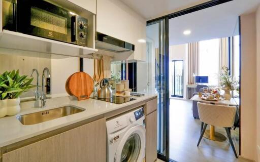 Modern kitchen with amenities and a view of a dining area