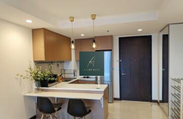 Modern kitchen with bar seating and indoor plants