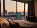 bedroom with city view during sunset