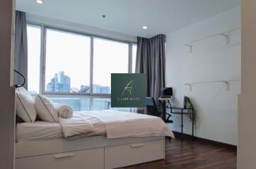 Modern bedroom with large windows and city view